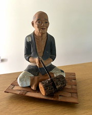 Ceramic Figurine of a Seated Barefoot Man Holding an Apple — listing 2