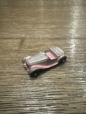 Blurry photograph of a vintage die-cast or tin toy automobile