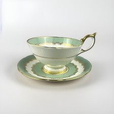 Porcelain Teacup and Saucer with Gold Scrolling Vine Pattern on Cream Ground — listing 6