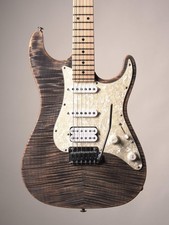 Suhr Electric Guitar (foreground headstock) with additional guitars on stand — listing 3