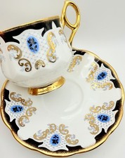 Porcelain Teacup and Saucer with Gold Scrolling Vine Pattern on Cream Ground — listing 5