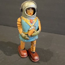 Vintage Battery-Operated Tin & Plastic Black Smoking Space Robot with Litho Chest and Red Feet