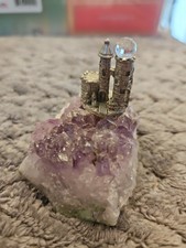 Pewter Castle/Tower Figurine with Faceted Crystal Point Spire Yes - there is text/logo on the bottom — listing 6
