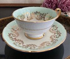 Porcelain Teacup and Saucer with Gold Scrolling Vine Pattern on Cream Ground — listing 3