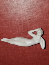 Vintage Bisque Porcelain Figurine of Seated Woman in Plumed Hat with Raised Leg