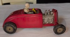 Blurry photograph of a vintage die-cast or tin toy automobile — listing 4