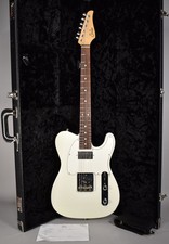 Suhr Electric Guitar (foreground headstock) with additional guitars on stand — listing 6
