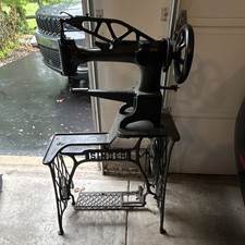 Antique Treadle Sewing Machine in Ornate Cast-Iron and Oak Cabinet