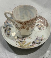 White Porcelain Footed Teacup with Embossed White Scrollwork Border and Platinum Trim