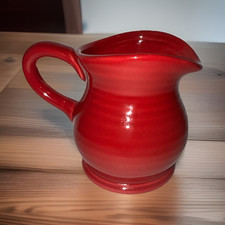 Ceramic item with red transfer-printed backstamp, maker unidentified (mark too blurred/smudged to read) — listing 5