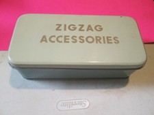 Mixed lot of vintage storage items on wooden vanity/dresser - decorative tins, sewing baskets, storage boxes, and knitting needles — listing 6