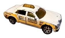 Blurry photograph of a vintage die-cast or tin toy automobile — listing 3