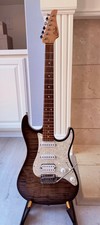 Suhr Electric Guitar (foreground headstock) with additional guitars on stand — listing 2