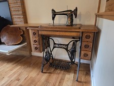 Singer Model 66 Treadle Sewing Machine with Red Eye Decals in Oak Cabinet — listing 2