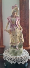 Vintage Bisque Porcelain Figurine of Seated Woman in Plumed Hat with Raised Leg — listing 4