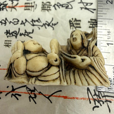 Carved Netsuke-Style Figure of Crouching Man Holding a Lantern Heavy, cool, dense — likely bone or ivor