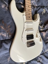 Suhr Electric Guitar (foreground headstock) with additional guitars on stand
