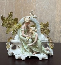 Porcelain figural spill vase with seated boy and rabbits, blue and white with hand-painted floral accents