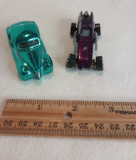 Blurry photograph of a vintage die-cast or tin toy automobile — listing 2