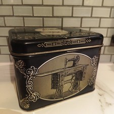 Mixed lot of vintage storage items on wooden vanity/dresser - decorative tins, sewing baskets, storage boxes, and knitting needles — listing 3
