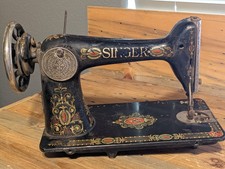 Singer Model 66 Treadle Sewing Machine with Red Eye Decals in Oak Cabinet — listing 3