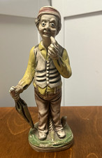 Ceramic Figurine of a Seated Barefoot Man Holding an Apple — listing 5