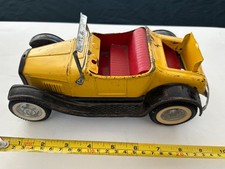 Blurry photograph of a vintage die-cast or tin toy automobile — listing 6